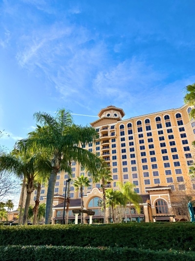 The exterior of Rosen Shingle Creek with palm trees and blue sky