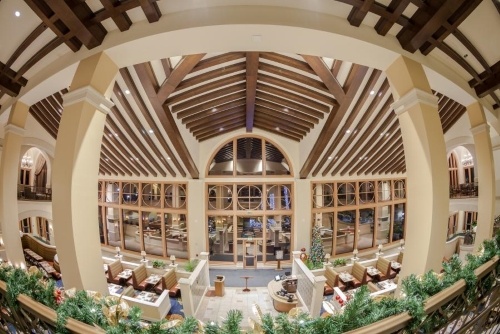 A fish-eye view of the wood beam ceiling and looking down into the Osceola Café. 