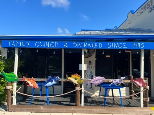 a blue awning reading “family owned & operated since 1995” hangs over a patio decorated with colorful fish caricatures. You can find some of the best seafood in Orlando at High Tide Harry’s.