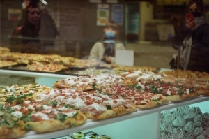 Tabletop counter filled with a variety of pizzas.